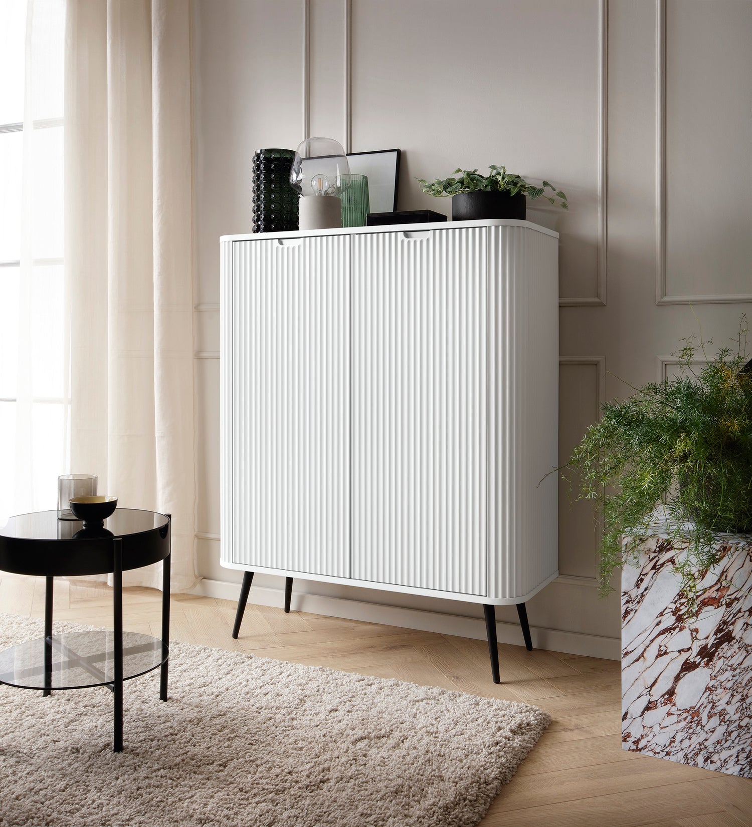 Storage cabinet ZOVA 03 whiteProduct description Dimensions Width 103cm Height 129cm Depth 39cm Details Colour white Material Laminated board 18mm / MDF-board 18mm Veneer ABS edges Legs Metal, in black (23cm) Warranty 24 monthsUncategorizedAnna Furniture